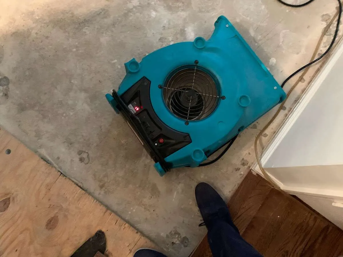 Air mover drying subfloor during Leak Detection & Repair in Colton